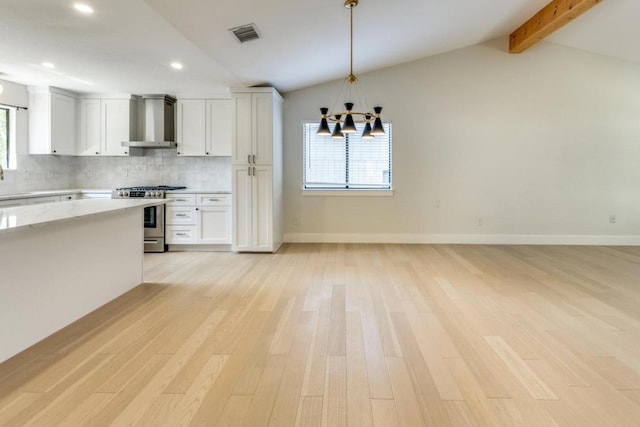 7901 Keswick Dr, Austin, TX 78745 - kitchen with gas range, wall chimney range hood, light wood finished floors, backsplash, and recessed lighting