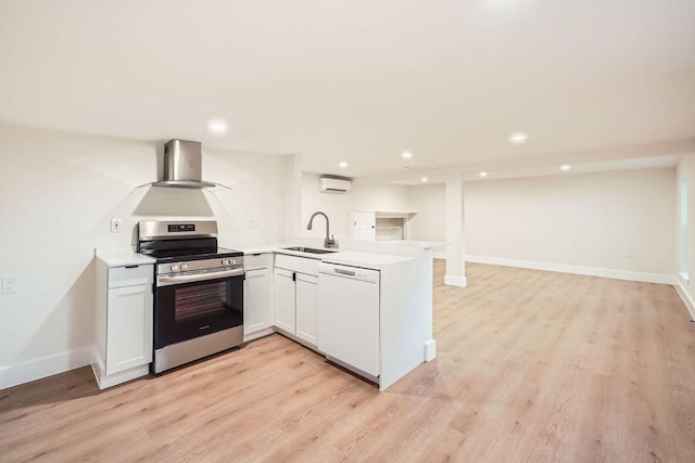 kitchen with electric range, a peninsula, a wall mounted AC, a sink, and dishwasher