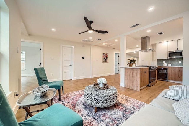901 E 55th St, Austin, TX 78751 - living area with beverage cooler, light wood-type flooring, a ceiling fan, and recessed lighting