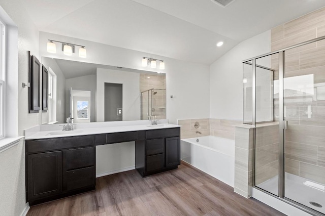 3756 Liberi Ln, Round Rock, TX 78665 - bathroom with a shower stall, double vanity, a bath, lofted ceiling, and wood finished floors