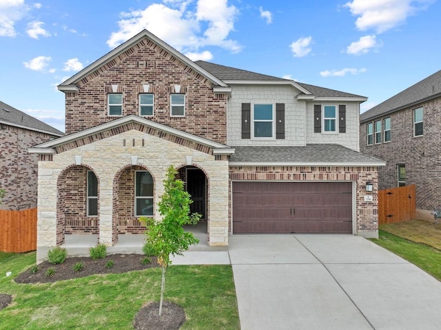 3756 Liberi Ln, Round Rock, TX 78665 - view of front facade featuring covered porch, a garage, concrete driveway, roof with shingles, and stone siding