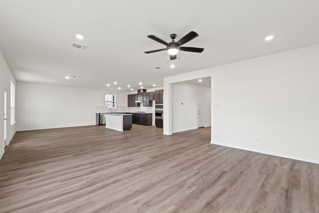 3756 Liberi Ln, Round Rock, TX 78665 - unfurnished living room featuring recessed lighting, a ceiling fan, light wood-style flooring, and baseboards