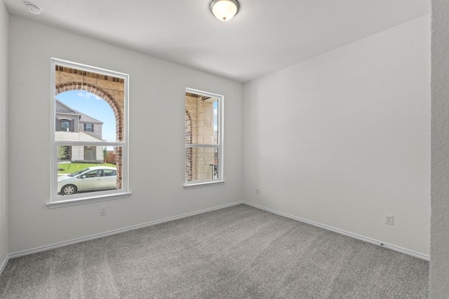 3756 Liberi Ln, Round Rock, TX 78665 - empty room with healthy amount of natural light, carpet, baseboards, and a smoke detector