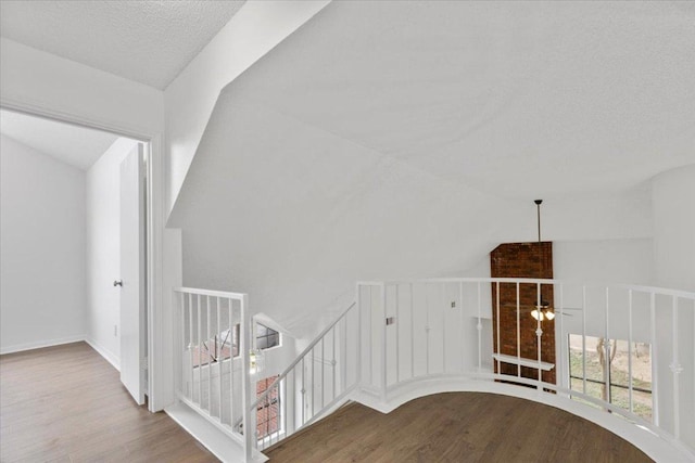 interior space featuring wood finished floors and vaulted ceiling