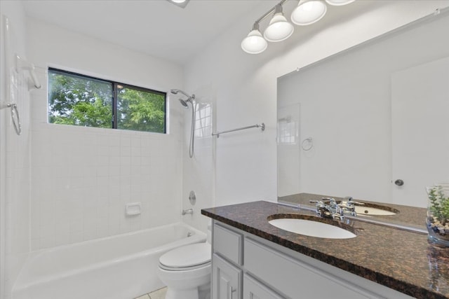 bathroom with toilet, shower / tub combination, and vanity