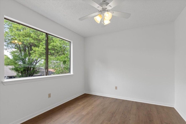 spare room featuring ceiling fan, wood finished floors, and baseboards