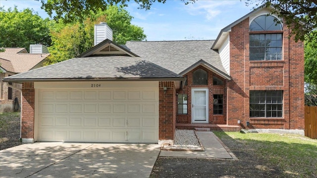 view of front facade featuring driveway, roof with shingles, an attached garage, and brick siding