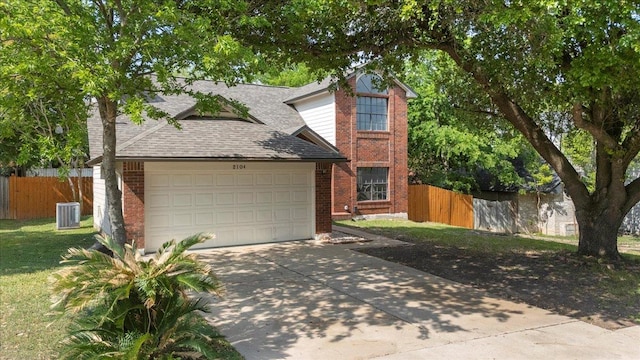 view of front of home with brick siding, fence, driveway, and an attached garage