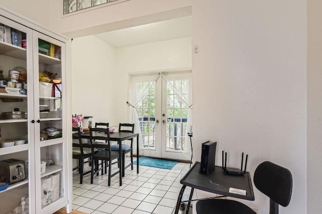 dining room featuring light tile patterned floors and french doors