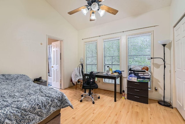 bedroom with ceiling fan, vaulted ceiling, and wood finished floors