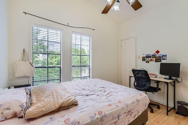 bedroom with wood finished floors, ceiling fan, and vaulted ceiling