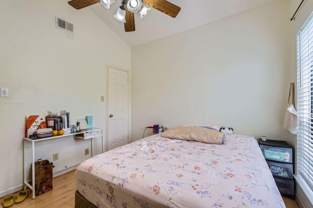 bedroom featuring light wood-type flooring, ceiling fan, baseboards, visible vents, and high vaulted ceiling