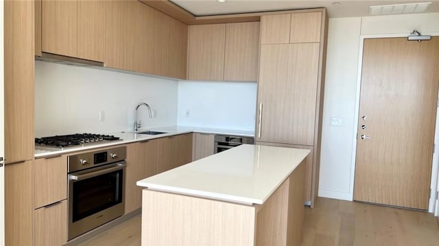 kitchen with appliances with stainless steel finishes, visible vents, modern cabinets, and a sink
