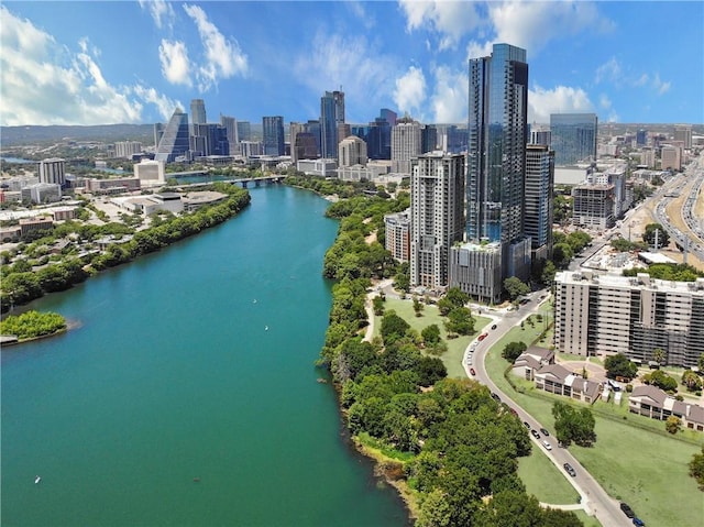 drone / aerial view featuring a view of city and a water view