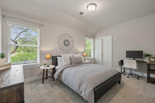 carpeted bedroom featuring baseboards, visible vents, and lofted ceiling