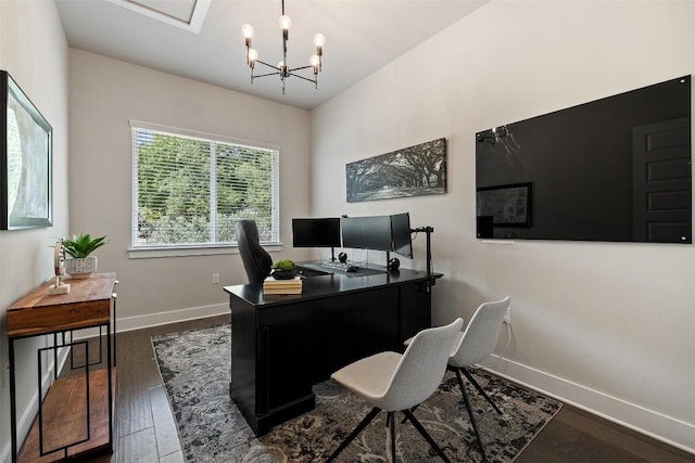 office space featuring baseboards, a notable chandelier, and dark wood-type flooring