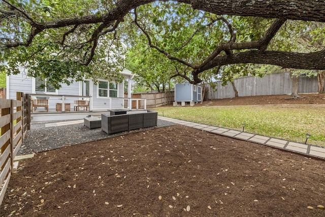 view of yard with an outbuilding, an outdoor hangout area, a fenced backyard, a storage unit, and a patio