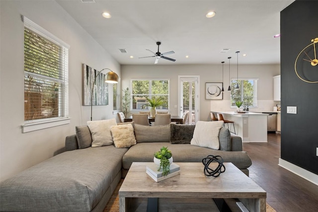 living room featuring dark wood-style flooring, ceiling fan, recessed lighting, and visible vents