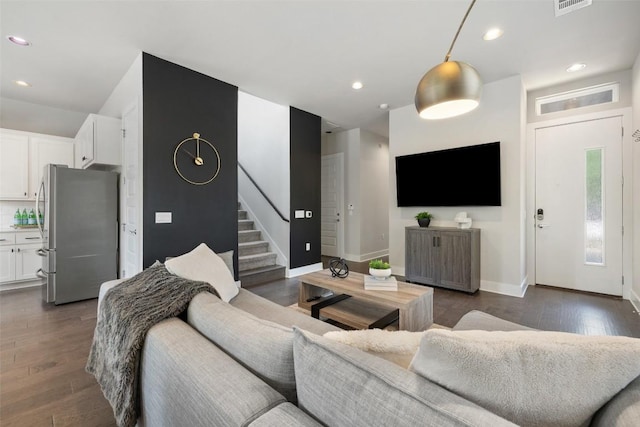 living area with stairway, baseboards, recessed lighting, and dark wood-style floors