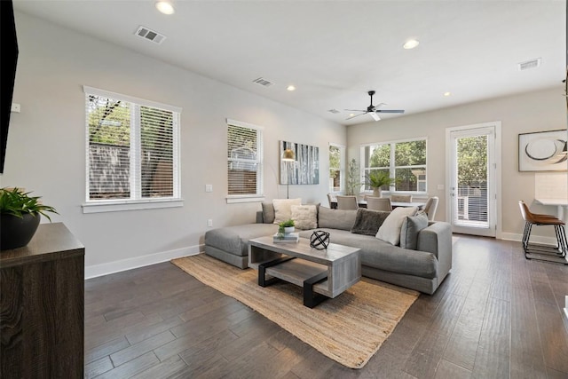 living room with a ceiling fan, baseboards, and visible vents