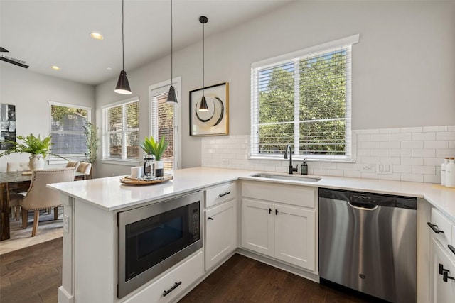 kitchen with stainless steel dishwasher, a sink, built in microwave, and tasteful backsplash