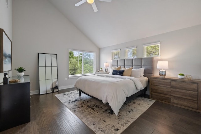bedroom with baseboards, dark wood-style flooring, ceiling fan, and high vaulted ceiling