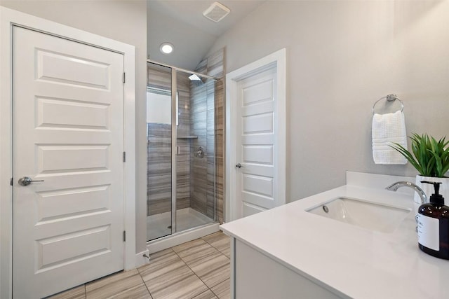full bathroom with visible vents, tile patterned floors, a stall shower, and vanity