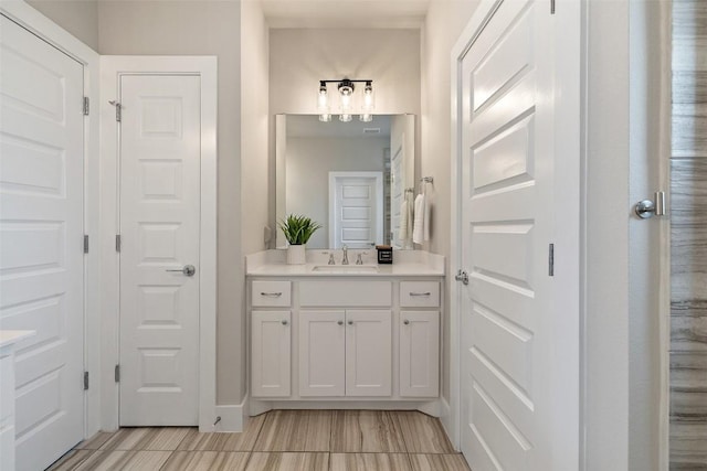 bathroom with baseboards and vanity