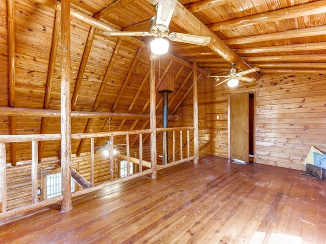 interior space featuring a ceiling fan, wooden ceiling, vaulted ceiling with beams, and hardwood / wood-style flooring
