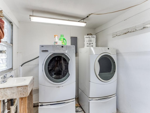 clothes washing area featuring washer and clothes dryer and laundry area