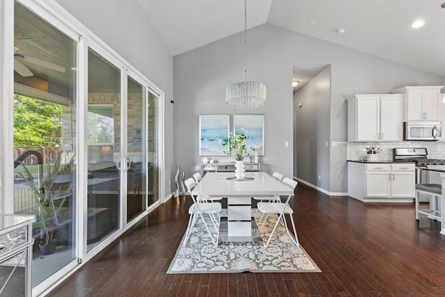 1401 Clearwing Cir, Georgetown, TX 78626 - dining space featuring dark wood finished floors, a chandelier, baseboards, and high vaulted ceiling