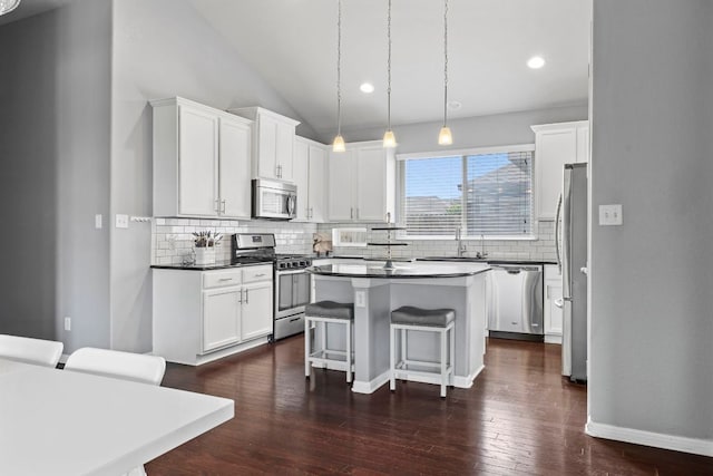 1401 Clearwing Cir, Georgetown, TX 78626 - kitchen featuring stainless steel appliances, a sink, decorative backsplash, a kitchen breakfast bar, and a center island