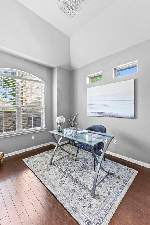 1401 Clearwing Cir, Georgetown, TX 78626 - office area featuring wood finished floors, a chandelier, baseboards, and lofted ceiling