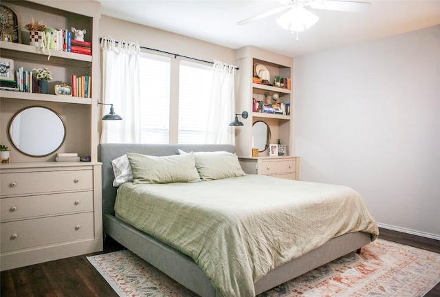 bedroom featuring dark wood-style floors, a ceiling fan, and baseboards