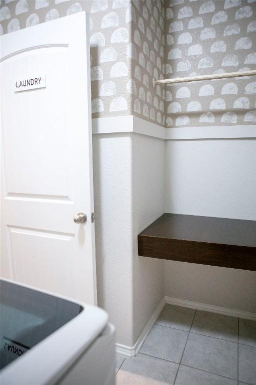 bathroom with tile patterned flooring and baseboards