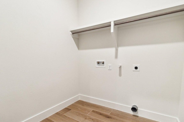 laundry room featuring light wood-style flooring, electric dryer hookup, baseboards, hookup for a washing machine, and laundry area