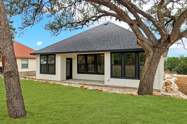 1313 Green Meadow Ln, Spring Branch, TX 78070 - rear view of property with roof with shingles, a yard, and board and batten siding