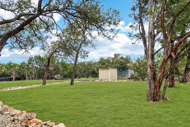view of yard featuring a shed and an outbuilding