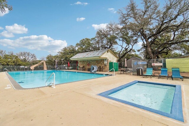 1313 Green Meadow Ln, Spring Branch, TX 78070 - community pool featuring a water slide and a patio area