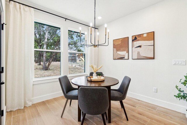 1313 Green Meadow Ln, Spring Branch, TX 78070 - dining space featuring a chandelier, baseboards, light wood-style flooring, and recessed lighting