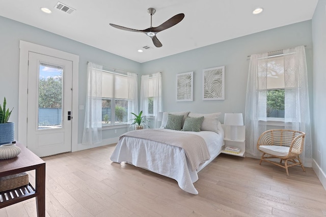 bedroom featuring visible vents, light wood finished floors, and multiple windows