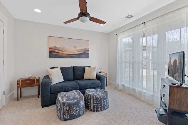 living area featuring light colored carpet, recessed lighting, ceiling fan, and visible vents