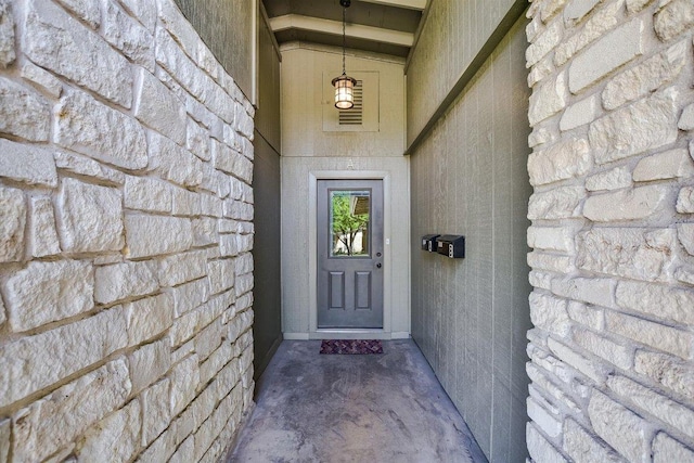 property entrance featuring stone siding