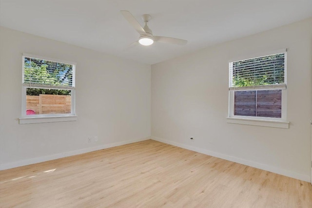 unfurnished room featuring baseboards, ceiling fan, and wood finished floors