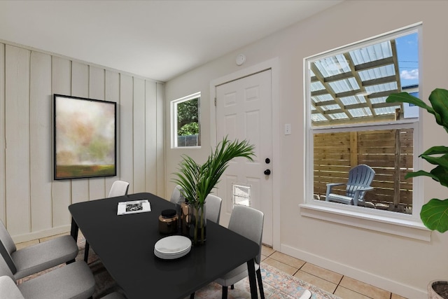 dining space with baseboards and light tile patterned floors