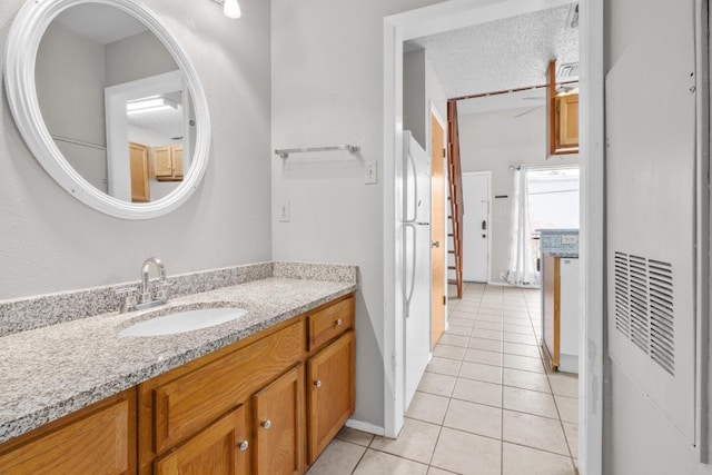 bathroom with tile patterned flooring, vanity, and a heating unit