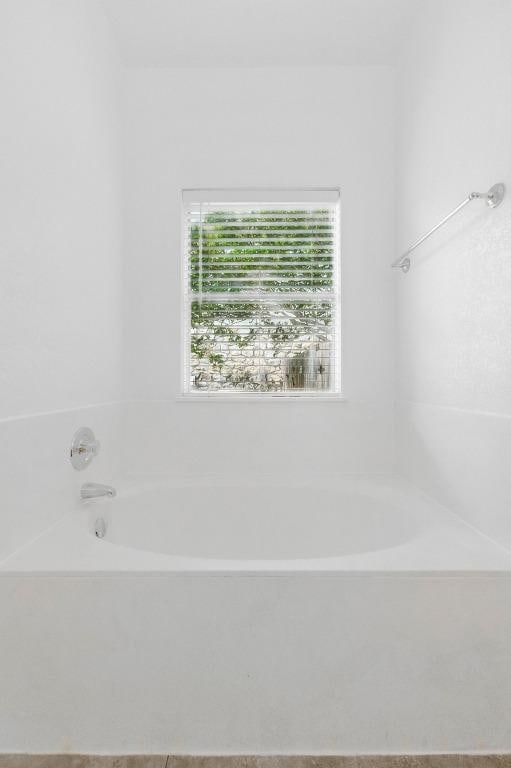 bathroom with a garden tub
