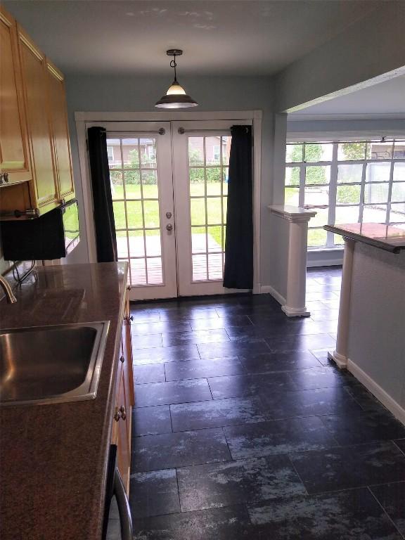 entryway featuring french doors, baseboards, and a sink