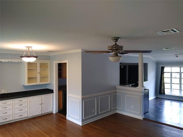 kitchen featuring crown molding, a ceiling fan, visible vents, and dark wood-type flooring