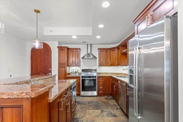 1812 W Ave Unit 306, Austin, TX 78701 - kitchen featuring appliances with stainless steel finishes, wall chimney exhaust hood, stone finish floors, recessed lighting, and brown cabinets